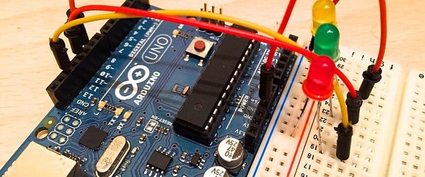 a close up of a arduino board with a bunch of wires connected to it .